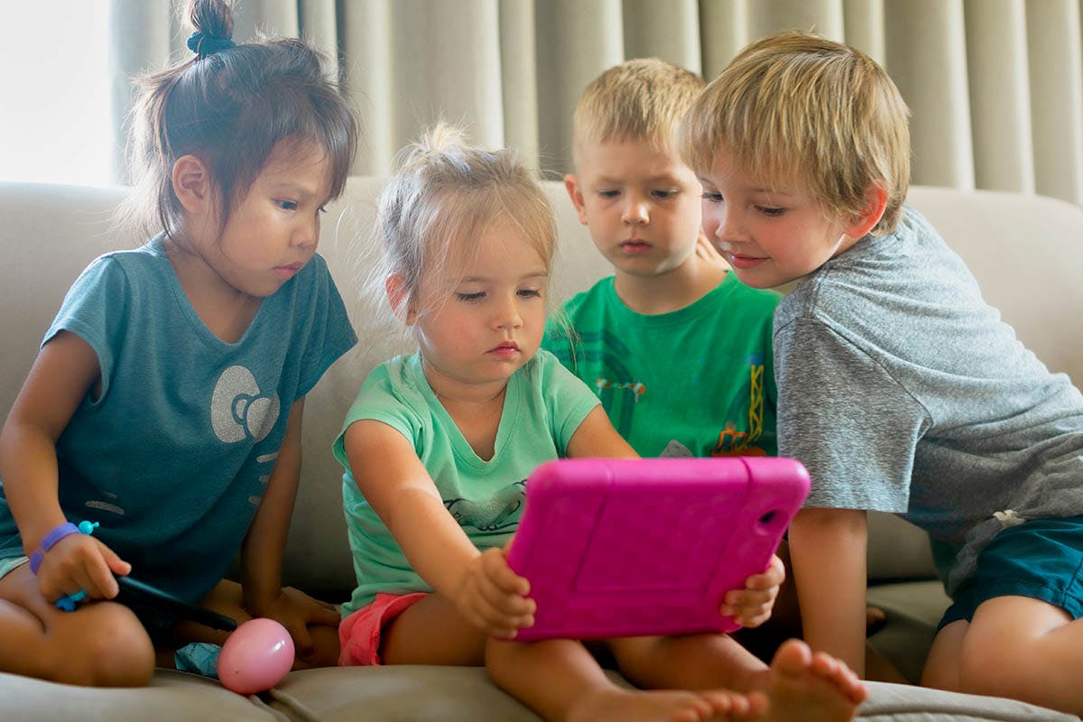children playing on a tablet while moving house